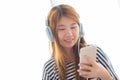 Beautiful asian young woman enjoy listen music with headphone an Royalty Free Stock Photo