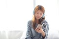 Beautiful asian young woman enjoy listen music with headphone an Royalty Free Stock Photo