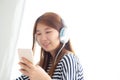 Beautiful asian young woman enjoy listen music with headphone an Royalty Free Stock Photo