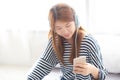 Beautiful asian young woman enjoy listen music with headphone and holding smart mobile phone while sitting in bedroom, relax girl Royalty Free Stock Photo