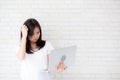 Beautiful asian young woman hipster using working laptop thinking idea on cement concrete background. Royalty Free Stock Photo