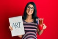 Beautiful asian young woman holding art notebook and colored pencils smiling looking to the side and staring away thinking Royalty Free Stock Photo