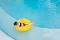 Beautiful asian young woman with inflatable ring relaxing in blue swimming pool. Top view Royalty Free Stock Photo