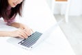 Beautiful asian young woman lying on bed using laptop at bedroom Royalty Free Stock Photo