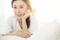 Beautiful Asian young woman relaxing on bed Royalty Free Stock Photo
