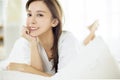 Beautiful Asian young woman relaxing on bed Royalty Free Stock Photo