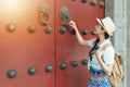 Woman play knock wooden red door Royalty Free Stock Photo