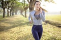 Beautiful asian young woman running in the park at  morning Royalty Free Stock Photo