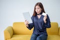 Beautiful asian young woman showing credit card holding digital tablet computer shopping online . wow . smiling excited girl with Royalty Free Stock Photo