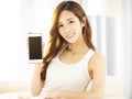 Beautiful young woman showing the smart phone Royalty Free Stock Photo