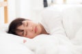 Beautiful asian young woman sleeping lying in bed with head on pillow comfortable and happy. Royalty Free Stock Photo