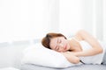 Beautiful asian young woman sleeping lying in bed with head on pillow comfortable and happy. Royalty Free Stock Photo