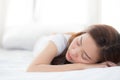 Beautiful asian young woman sleeping lying in bed with head on pillow comfortable and happy. Royalty Free Stock Photo