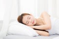 Beautiful asian young woman sleeping lying in bed with head on pillow comfortable and happy. Royalty Free Stock Photo