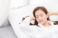 Beautiful asian young woman sleeping lying in bed with head on pillow comfortable and happy. Royalty Free Stock Photo