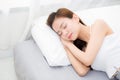 Beautiful asian young woman sleeping lying in bed with head on pillow comfortable and happy. Royalty Free Stock Photo