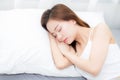 Beautiful asian young woman sleeping lying in bed with head on pillow comfortable and happy. Royalty Free Stock Photo