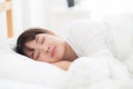 Beautiful asian young woman sleeping lying in bed with head on pillow comfortable and happy. Royalty Free Stock Photo