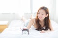 Beautiful asian young woman turn off alarm clock in morning, wake up for sleep with alarm clock. Royalty Free Stock Photo