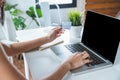 Beautiful Asian young woman using credit card shopping online with laptop at home Royalty Free Stock Photo