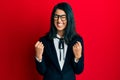 Beautiful asian young woman wearing business suit excited for success with arms raised and eyes closed celebrating victory smiling Royalty Free Stock Photo