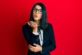 Beautiful asian young woman wearing business suit looking at the camera blowing a kiss with hand on air being lovely and sexy Royalty Free Stock Photo