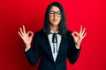 Beautiful asian young woman wearing business suit relax and smiling with eyes closed doing meditation gesture with fingers Royalty Free Stock Photo