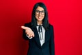 Beautiful asian young woman wearing business suit smiling friendly offering handshake as greeting and welcoming Royalty Free Stock Photo