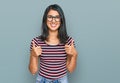 Beautiful asian young woman wearing casual clothes and glasses success sign doing positive gesture with hand, thumbs up smiling Royalty Free Stock Photo