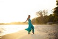 Beautiful asian younger woman wearing  green dress relaxing on summer vacaiton beach Royalty Free Stock Photo