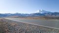 Beautiful asphalt road without cars and people in a desert area towards mount Elbrus. Autumn landscape in the Caucasus. Empty road