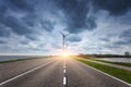 Beautiful asphalt road with wind turbines Royalty Free Stock Photo