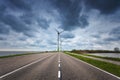 Beautiful asphalt road with wind turbines Royalty Free Stock Photo
