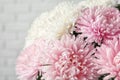 Beautiful aster flower bouquet near brick wall