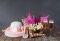 Beautiful astilbe and hydrangea flowers  glasses of rose champagne  summer hat  cherry ice cream and waffle cones on wooden table Royalty Free Stock Photo