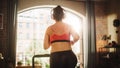 Beautiful Athletic Plus Size Body Positive Sports Woman Running on a Treadmill at Her Home Gym Royalty Free Stock Photo