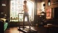 Beautiful Athletic Sports Woman Running on a Treadmill at Her Home Gym. Energetic Workout: Female Royalty Free Stock Photo