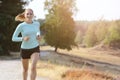 Beautiful sporty woman jogging, running and training outdoors on a sunny day in summer Royalty Free Stock Photo