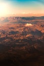 Beautiful atmospheric mountain landscape from the porthole of a flying plane