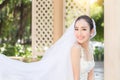 Beautiful Attractive Asian Bride Woman wearing white wedding dress and holding bouquet smile