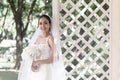 Beautiful Attractive Asian Bride Woman wearing white wedding dress and holding bouquet smile Royalty Free Stock Photo