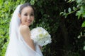 Beautiful Attractive Asian Bride Woman wearing white wedding dress and holding bouquet smile Royalty Free Stock Photo