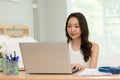 Beautiful Attractive Asian indian woman working with computer laptop and thinking to get ideas and requirement in Business startup Royalty Free Stock Photo