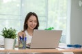 Beautiful Attractive Asian indian woman working with computer laptop and thinking to get ideas and requirement in Business startup Royalty Free Stock Photo