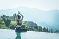 woman practice yoga on the pool above the Mountain peak Royalty Free Stock Photo