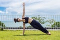 Beautiful Attractive Asian woman practice yoga side plank pose stretching exercises muscle Royalty Free Stock Photo