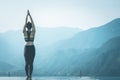 Beautiful Attractive Asian woman practice yoga Surya Namaskar exercise Ekam pose on the pool above the Mountain peak Royalty Free Stock Photo