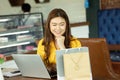 Beautiful Attractive Asian woman using computer laptop shopping online with shopping bags Royalty Free Stock Photo