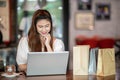 Beautiful Attractive Asian woman using computer laptop shopping online with shopping bags inside feeling so enjoy Royalty Free Stock Photo