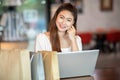 Beautiful Attractive Asian woman using computer laptop shopping online with shopping bags inside feeling so enjoy Royalty Free Stock Photo